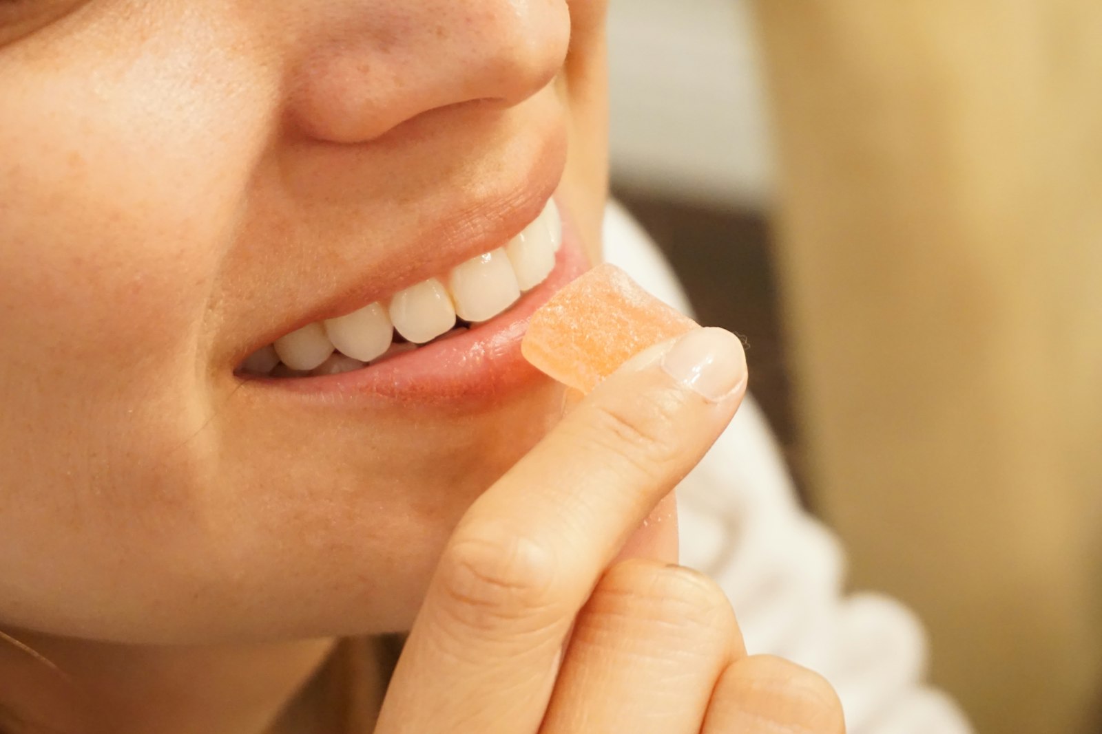 A person taking a single measured cannabis gummy
